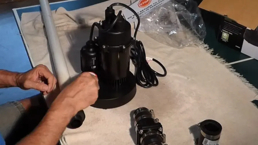 Sump pump basin, discharge pipe, and pump components during a plumbing service visit in Las Flores