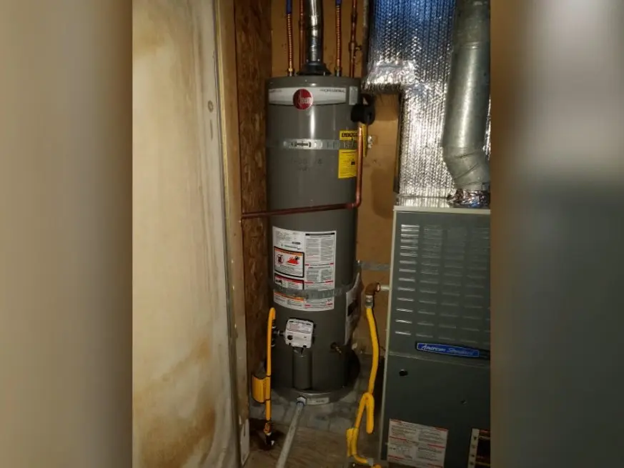 Residential water heater tank, supply lines, and service fittings during a plumbing service visit in East Altadena on the ea-side-01 section